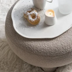 Pouf rond en tissu bouclé